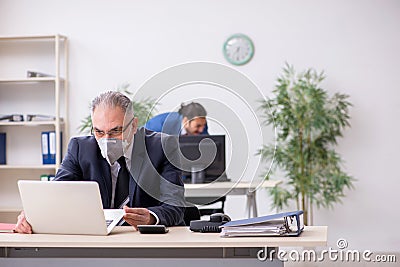 Two employees at workplace during pandemic Stock Photo
