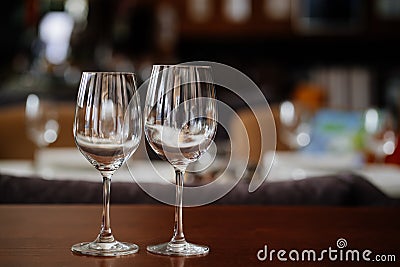 two empty clean wine glasses on a wooden table. utensils for alcoholic beverages Stock Photo