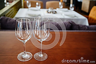 two empty clean wine glasses on a wooden table. utensils for alcoholic beverages Stock Photo