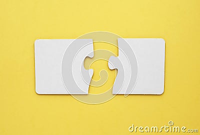 Two empty puzzles for text on a yellow Stock Photo