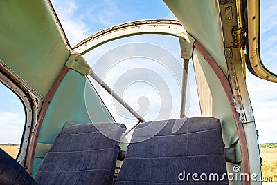 Two empty seats in cockpit of old small plane. Open captain cabin Stock Photo