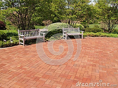 Two empty wood benches by a red patio Stock Photo