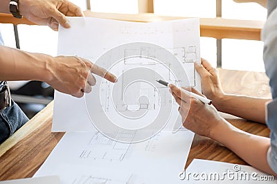 Two engineers discussion on architectural project at construction site at modern office Stock Photo