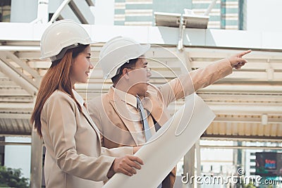Two engineers meeting at construction site. Coworkers discussing. Stock Photo