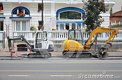 Two excavators in offense at each other Stock Photo