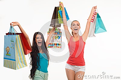 Two excited girls with shopping bags. Stock Photo