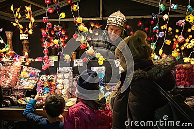 Two excited kids with their grandma in a christmas market Editorial Stock Photo