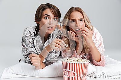 Two excited pretty girls wearing pajamas Stock Photo