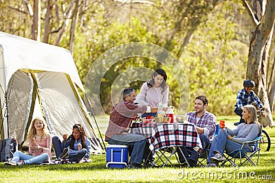 Two Families Enjoying Camping Holiday In Countryside Stock Photo