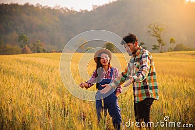 Two farmers man and woman standing in a wheat field Stock Photo