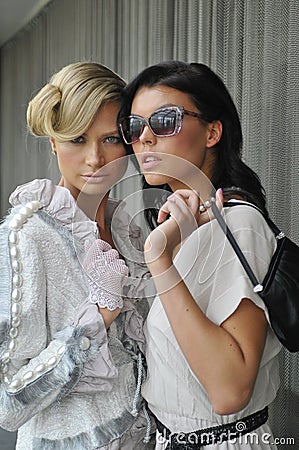 Two fashion models wearing couture clothes and accessories Stock Photo