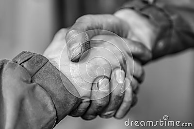 Two fellow workers greeting each other with a handshake Stock Photo