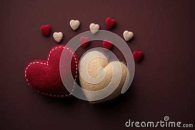 Two felted cute beige and red pastel romantic hearts on a deep red background with copy space, Vintage valentine's day or Stock Photo