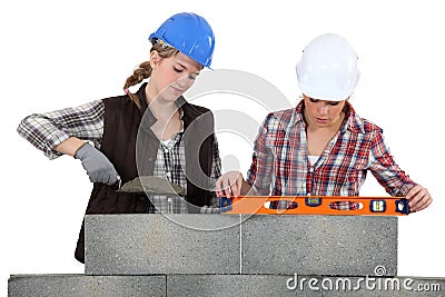 Two female bricklayers Stock Photo