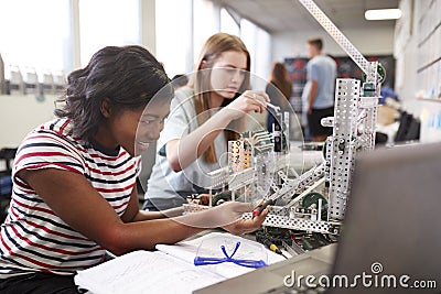 Two Female College Students Building Machine In Science Robotics Or Engineering Class Stock Photo