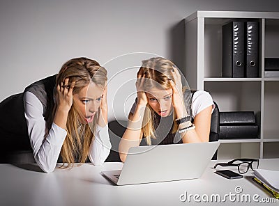 Two female coworkers looking at computer Stock Photo