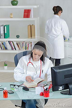 Two female doctors coleagues in office Stock Photo