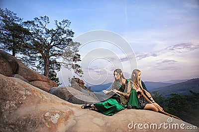 Two female elves walking in the woods Stock Photo