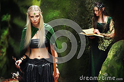 Two female elves walking in the woods Stock Photo