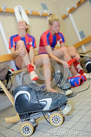 Two female roller hockey players in changing room Stock Photo