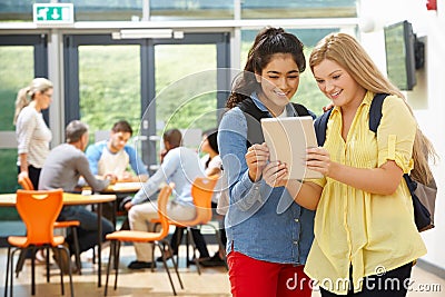 Two Female Teenage Students In Classroom With Digital Tablet Stock Photo