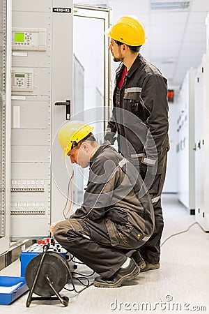 Field service engineers inspect system with relay test set equip Stock Photo