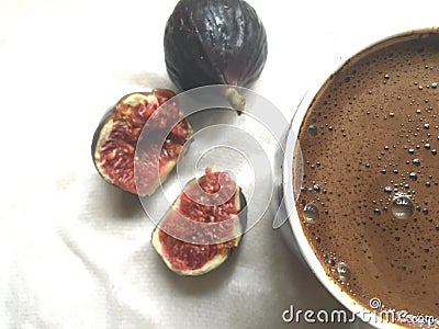 A pulp of fresh figs and mug of coffee on a white tissue Stock Photo