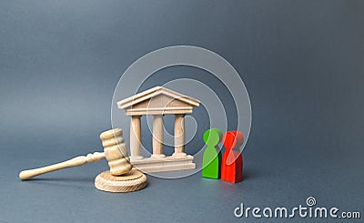 Two figures of people opponents stand near the courthouse and the judge`s gavel. The judicial system. Conflict resolution Stock Photo