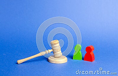 Two figures of people opponents stand near the judge`s gavel. The judicial system. Conflict resolution in court, claimant Stock Photo