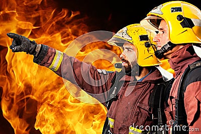 Two firemen analyzing fire. Stock Photo
