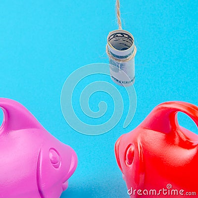 Two fish are following dollar banknote on a string as a bait Stock Photo