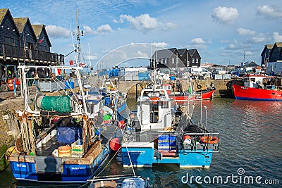 Two fishermen prepare to head out fishing on their boats at Whitstable Harbour in Kent, England. Editorial Stock Photo