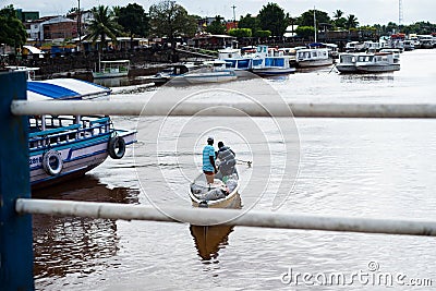 Two fishermen sail on the Una river in the city of Valenca in Bahia Editorial Stock Photo