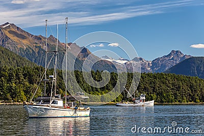 Two fishing boats sailing in harbor in Alaska Stock Photo