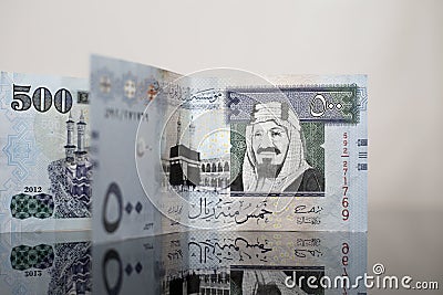 Two five hundred Saudi Riyal notes on Dark Glass Stock Photo