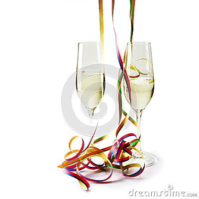 Two flute champagne glasses with colorful paper streamers on white Stock Photo