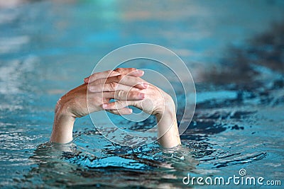 Two folded hands above water Stock Photo