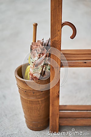 Two folded umbrellas in a wooden basket Stock Photo
