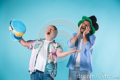 The two football fans over blue Stock Photo