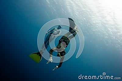 Two freedivers have fun in the depth Stock Photo