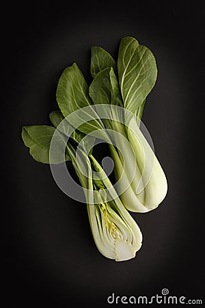 Two fresh green Bok Choy on a dark slate background, tasty ingredients and low in calories Stock Photo