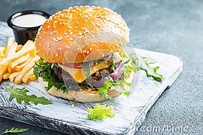 Two fresh homemade burgers with fried potatoes on a stone table Stock Photo