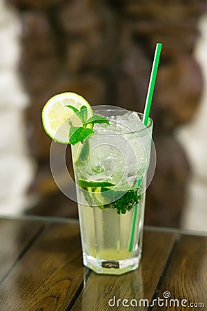 Two fresh mojitos cocktail on wooden background. Mojitos with mint leaves, lime and ice. Stock Photo