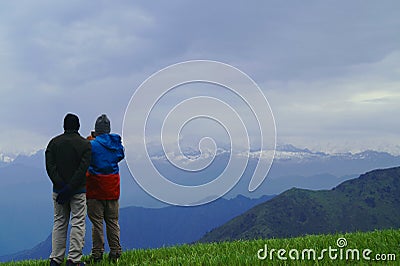 Two friend watching mountain range and waiting for sunrise Stock Photo