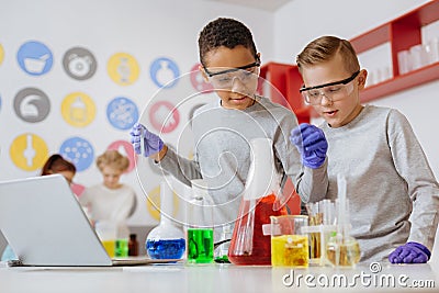 Two friends experimenting with chemicals in lab Stock Photo