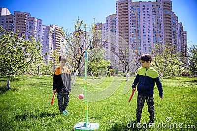 Two friends are playing tetherball swing ball game in summer camping. Two boy brother happy leisure healthy active time outdoors Stock Photo