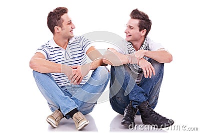 Two friends smiling to each other Stock Photo