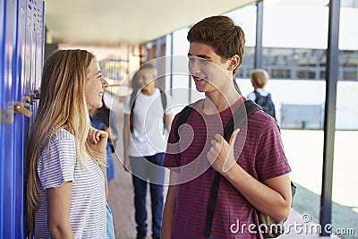 Two friends talking in school corridor at break time Stock Photo