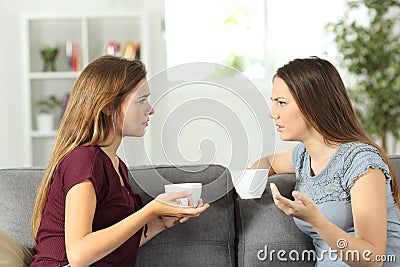 Two friends talking seriously at home Stock Photo