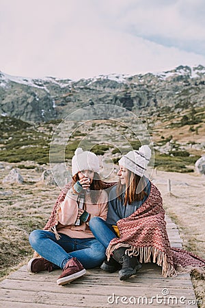 Some friends enjoy the mountain while they are sitting taking a broth Stock Photo